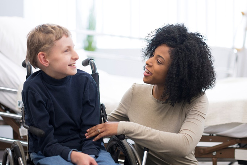 woman with boy in wheel chair